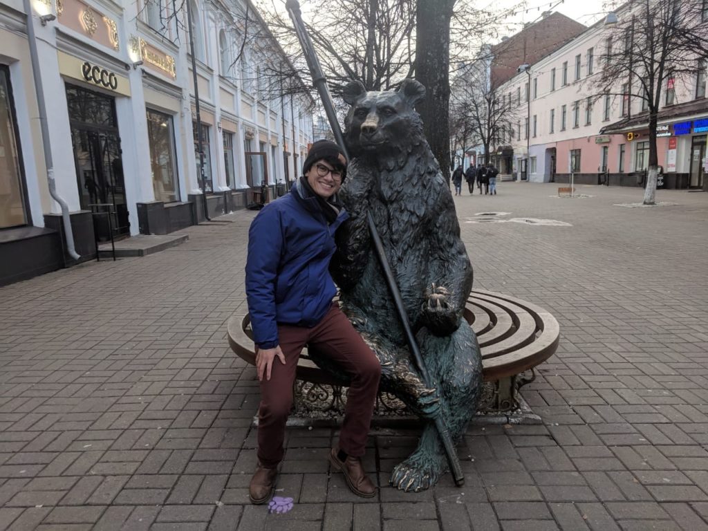 Cameron posing with a bear statue in Yaroslavl, Russia