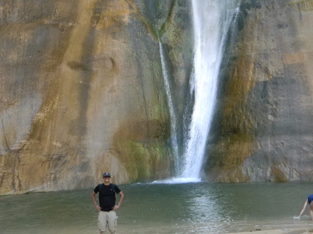 Cameron standing near a small waterfall in Grand Staircase-Escalante.