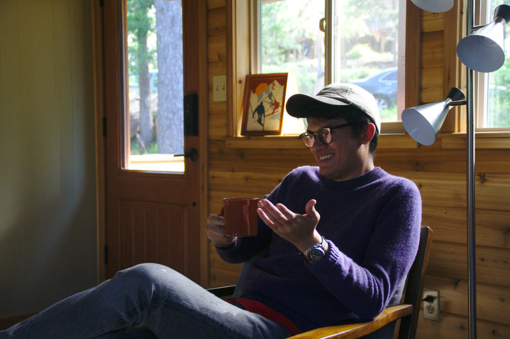Cameron drinking coffee in a cabin in Mi-Wuk Village, California